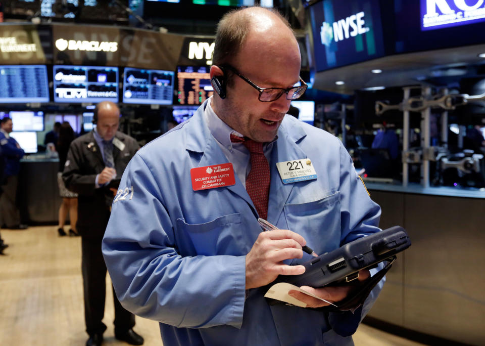 Trader Peter Mancuso works on the floor of the New York Stock Exchange, Tuesday, May 13, 2014. The Standard & Poor's 500 index crossed above 1,900 for the first time Tuesday as investors assessed news on retail sales. DirecTV gained on reports that the AT&T is poised to buy the company for nearly $50 billion. (AP Photo)