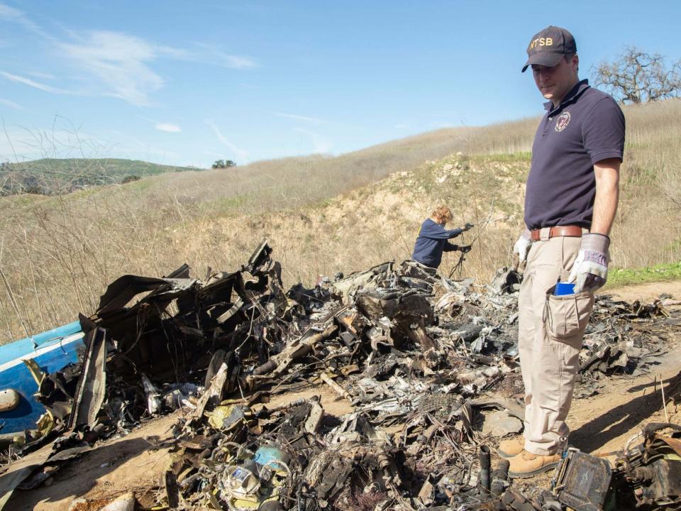 NTSB investigators search through the wreckage of the helicopter that crashed carrying Kobe Bryant and his daughter: AP