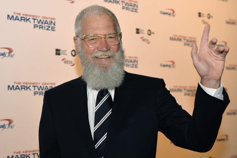 David Letterman greets photographers on the red carpet as he arrives at the John F. Kennedy Center for the Performing Arts for a gala to honor his Mark Twain Prize for American Humor award at the Kennedy Center, October 22 in Washington, D.C. On April 3, 2014, longtime late-night TV host David Letterman announced he would retire in 2015. File Photo by Mike Theiler/UPI