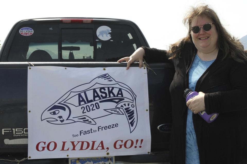 Sarah Spanos displays signs of support for Olympic swimmer Lydia Jacoby adorning her pickup truck, in Seward, Alaska, Tuesday, July 27, 2021. Jacoby, a 17-year-old from Seward, scored a major upset when the first Alaskan ever on the U.S. Olympics swimming team won the gold medal in the 100-meter breaststroke at the Tokyo Games. (AP Photo/Mark Thiessen)