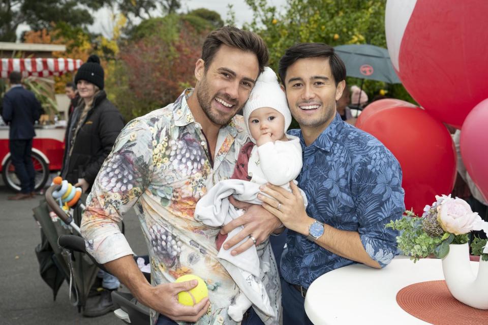 aaron brennan and david tanaka with isla in neighbours