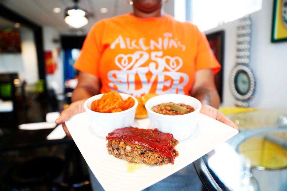 A platter with meatloaf, black-eyed peas, and candy yams at Alcenia's.