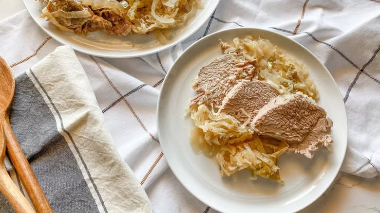 Pork slices with sauerkraut on plate