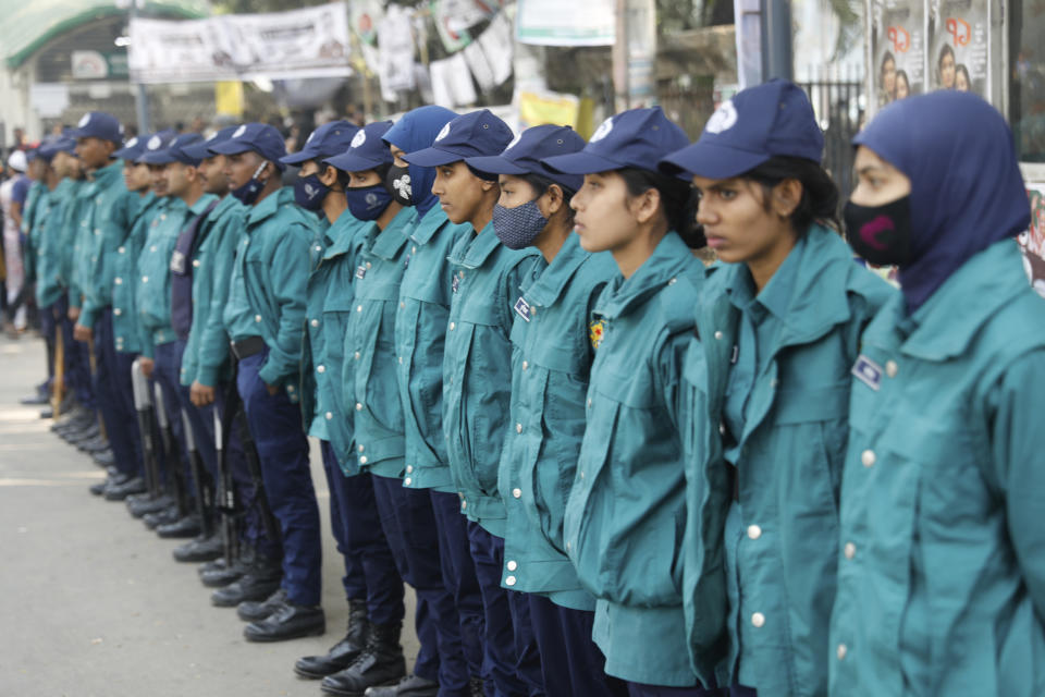 Bangladesh Police keep guard on a street ahead of elections in Dhaka, Bangladesh, Friday, Jan. 5, 2024. Bangladesh’s main opposition party called for general strikes on the weekend of the country's parliamentary election, urging voters to join its boycott. This year, ballot stations are opening amid an increasingly polarized political culture led by two powerful women; current Prime Minister Sheikh Hasina and opposition leader and former premier Khaleda Zia. (AP Photo/Mahmud Hossain Opu)