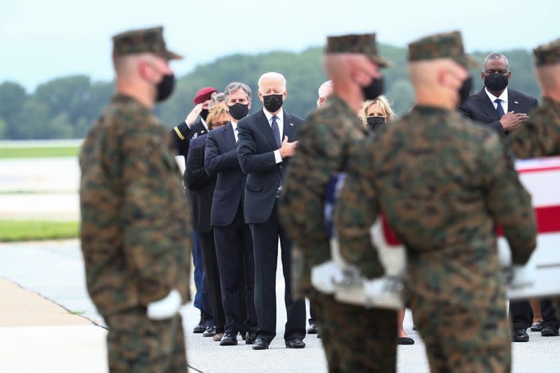 U.S. President Joe Biden salutes during the dignified transfer of the remains of U.S. Military service members who were killed by a suicide bombing at the Hamid Karzai International Airport