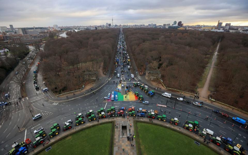 Farmers protest against the German government's planned cuts to agricultural sector subsidies near the Brandenburg Gate in Berlin