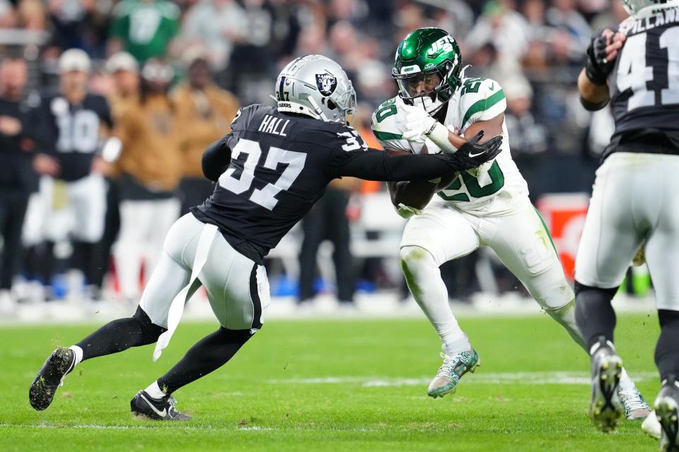 Nov 12, 2023; Paradise, Nevada, USA; New York Jets running back Breece Hall (20) is tackled by Las Vegas Raiders cornerback Tyler Hall (37) during the fourth quarter at Allegiant Stadium. Mandatory Credit: Stephen R. Sylvanie-USA TODAY Sports