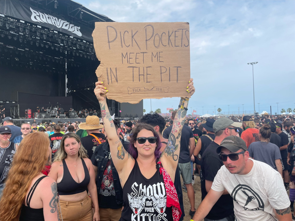 Rachel Pikarsky holds up a sign welcoming pickpockets to meet her in the mosh pit on Sunday at Welcome to Rockville. Pikarsky was one of several victims of theft this week and had her phone stolen during Mudvayne’s performance on Thursday.