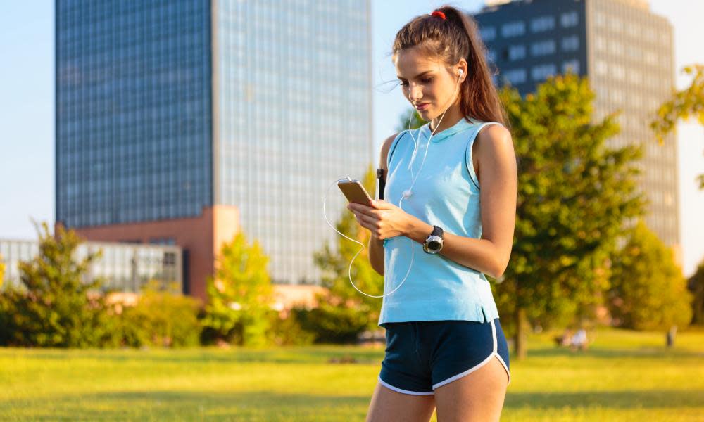 Woman with mobile in sporty clothes