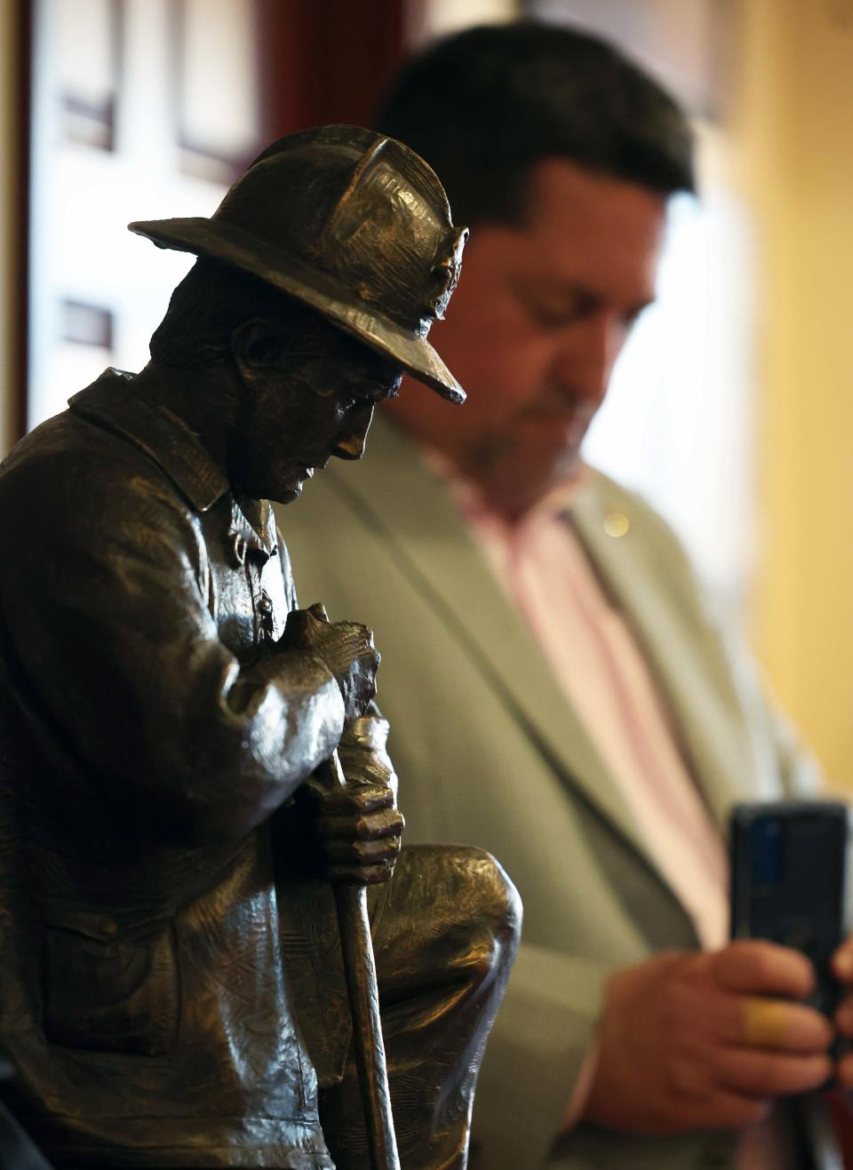 Brockton Firefighters Local 144 Bill Hill makes a video while he waits to speak at Keating Hall during a community rally on Wednesday, April 24, 2024, to keep Good Samaritan Medical Center open amid the financial crisis enveloping its owner, Steward Health Care.