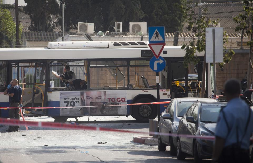 TEL AVIV, ISRAEL- NOVEMBER 21: Emergency services at the scene of an explosion on a bus with passengers onboard on November 21, 2012 in central Tel Aviv, Israel. At least ten people have been injured in a blast on a bus near military headquarters in what is being described as terrorist attack which threatens to derail ongoing cease-fire negotiations between Israeli and Palestinian authorities. (Photo by Ziv Oren/Getty Images)