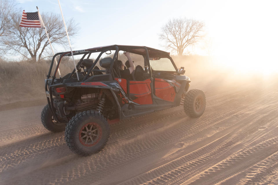 An off-roader rides into the sun at the annual Sand Dregs event Saturday at the Canadian River north of Amarillo.