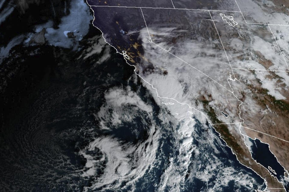 This satellite image provided by NOAA shows a storm over Southern California Thursday, Dec. 21, 2023. The Pacific storm pounded parts of Southern California with heavy rain and street flooding, adding to hassles as holiday travel got underway. The early morning downpours targeted coastal Ventura County, just to the northwest of Los Angeles County, swamping areas in the cities of Oxnard and Port Hueneme. (CIRA/NOAA via AP)