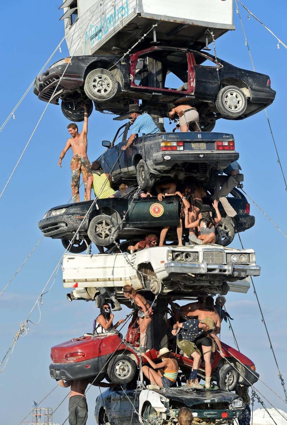 Burners climb around on an art installation titled Night of the Climb by Dustin Weatherford at Burning Man on Monday August 27, 2018. 