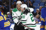 Dallas Stars defenseman Ryan Suter (20) celebrates his goal against the Buffalo Sabres with left wing Mason Marchment (27) during the second period of an NHL hockey game Thursday, March 9, 2023, in Buffalo, N.Y. (AP Photo/Jeffrey T. Barnes)