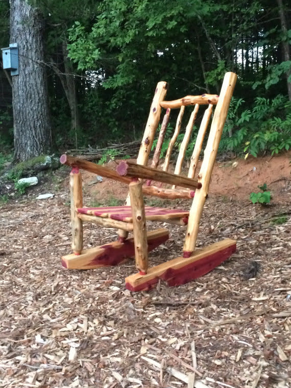 Toss a throw pillow and woolen throw across this rocking chair, and it's the most inviting seat in the house. <a href="https://www.etsy.com/listing/252965168/rustic-cedar-log-rocking-chair-front" target="_blank">Shop it here</a>.&nbsp;