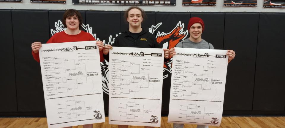 Donivon Dangerfield (left), Eathan Westfall (center) and Joey Campbell (right) won district championships for Reading wrestling.