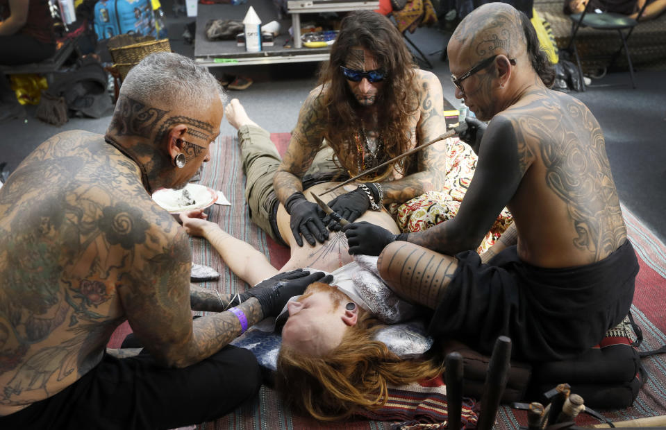 <p>A man gets a tattoo using a traditional hand-tapping method at The International Tattoo Convention in London, Friday, Sept. 22, 2017. (Photo: Kirsty Wigglesworth/AP) </p>