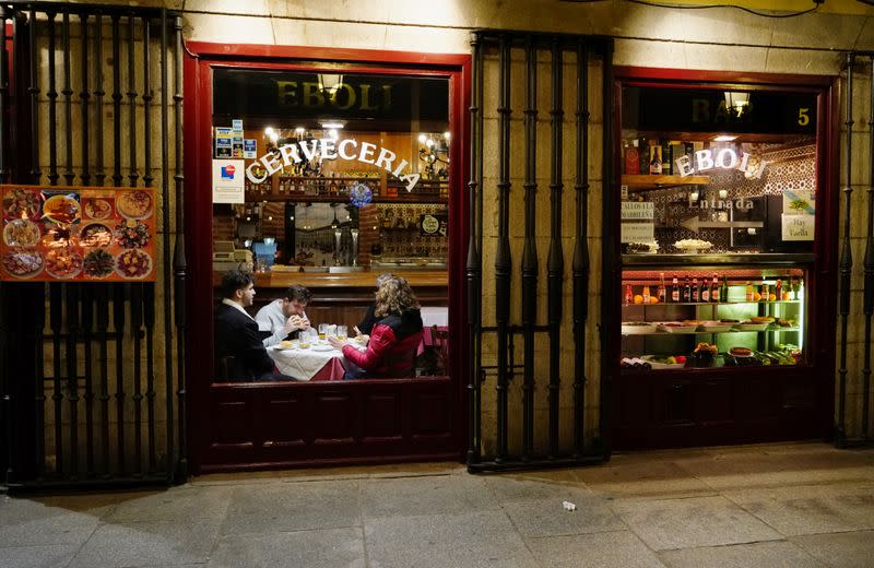 People sit inside a bar amid the coronavirus disease (COVID-19) pandemic in Madrid