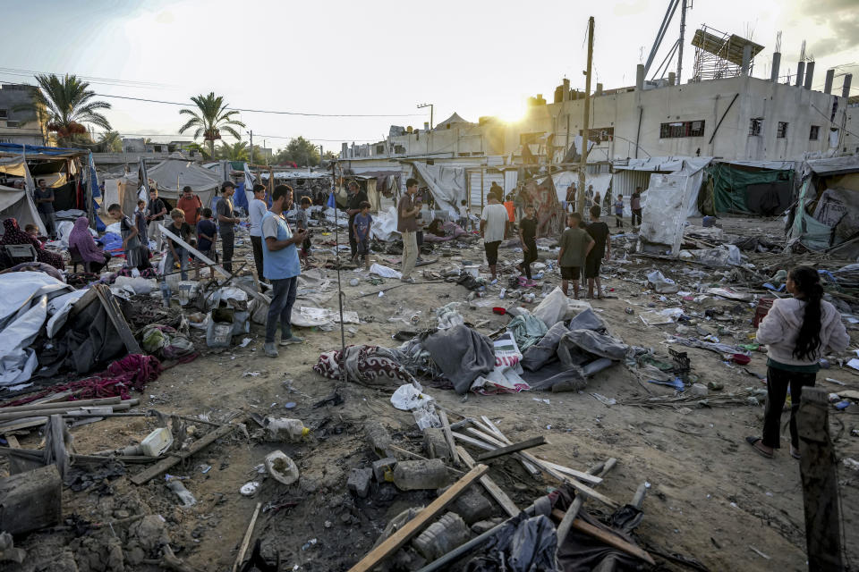 Palestinians inspect the damage at a tent area in the courtyard of Al Aqsa Martyrs hospital, hit by an Israeli bombardment on Deir al-Balah, central Gaza Strip, Thursday, Sept. 5, 2024. (AP Photo/Abdel Kareem Hana)