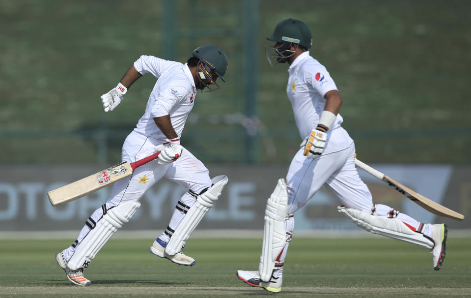 Pakistan's Sarfaraz Ahmed, left, and Babar Azam, run between the wickets against Australia during their test match in Abu Dhabi, United Arab Emirates, Thursday, Oct. 18, 2018. (AP Photo/Kamran Jebreili)