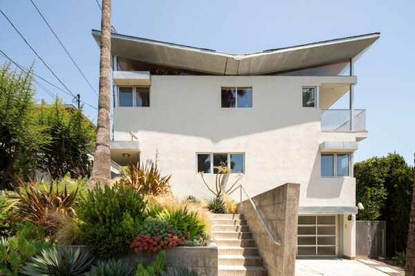 Located in the buzzing neighborhood of Silver Lake, the multi-level home presents mega curb appeal thanks to its thoughtfully designed butterfly roof and verdant landscaping.
