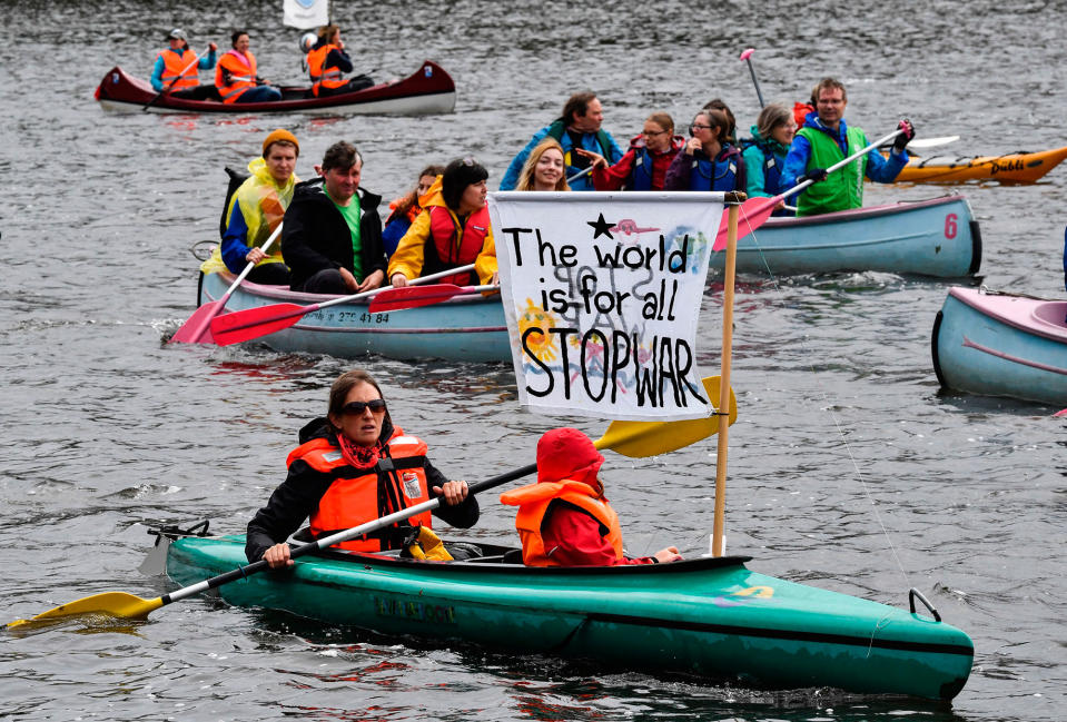 <p>Protest boats pass on the Alster river are pictured during a demonstration called by several NGOs ahead of the G20 summit in Hamburg on July 2, 2017. (John MacDougall/AFP/Getty Images) </p>