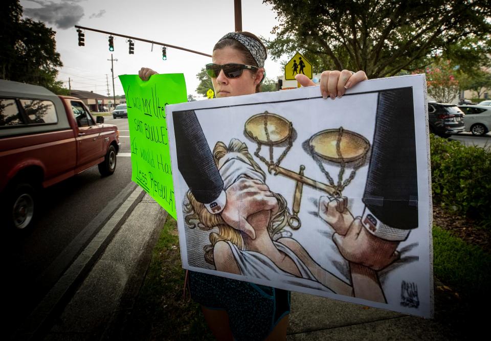Carla Horn protests the Supreme Court decision overturning Roe v. Wade on South Florida Avenue in Lakeland on Friday.