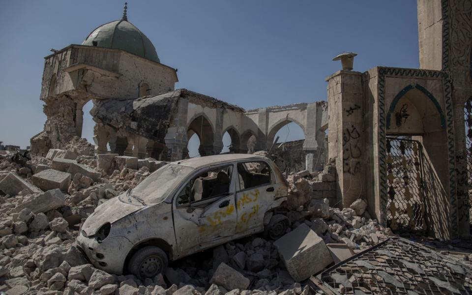 A dome and a series of arches remain in the bombed out shell of Al Nouri mosque - Sam Tarling for The Telegraph