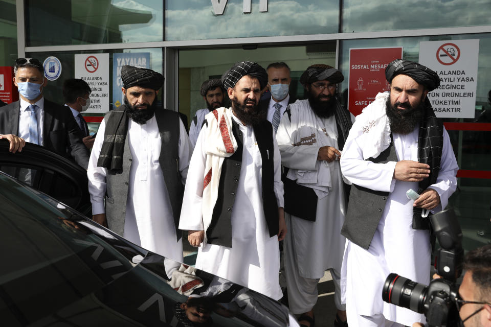 The Taliban delegation led by Amir Khan Muttaqi, the acting foreign minister, walk at Esenboga Airport, in Ankara, Turkey, Thursday, Oct. 14, 2021. A high-level delegation of Afghanistan's new Taliban rulers has arrived in Turkey for talks with Turkish officials, the Foreign Ministry announced Thursday. The meetings in the capital of Ankara would be first between the Taliban and senior Turkish government officials after the group seized control of Afghanistan. (AP Photo/Burhan Ozbilici)