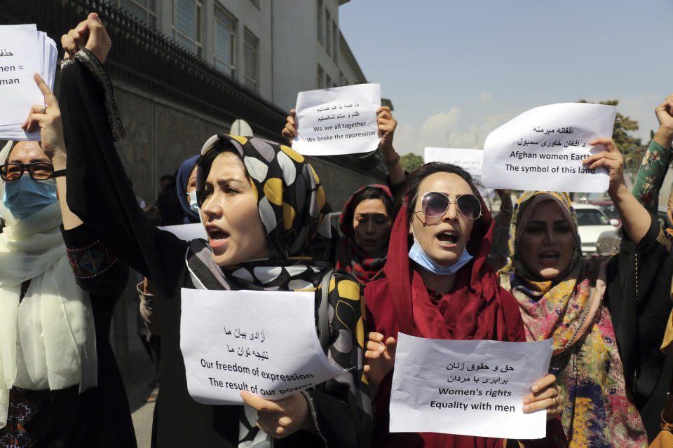 Women gather to demand their rights under the Taliban rule during a protest in Kabul, Afghanistan, Friday, Sept. 3, 2021. As the world watches intently for clues on how the Taliban will govern, their treatment of the media will be a key indicator, along with their policies toward women. When they ruled Afghanistan between 1996-2001, they enforced a harsh interpretation of Islam, barring girls and women from schools and public life, and brutally suppressing dissent. (AP Photo/Wali Sabawoon)