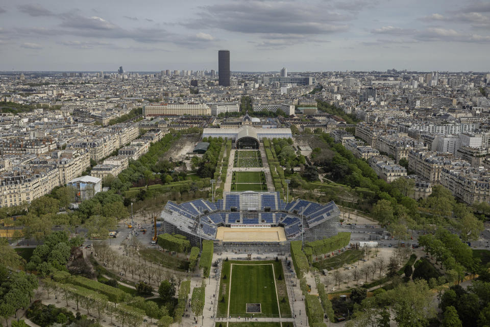 Stands are under construction on the Champ-de-Mars,with the Grand Palais Ephemere in background, Sunday, April 14, 2024 in Paris. The Champ-de-Mars stadium will host the Beach Volleyball and Blind Football at the Paris 2024 Olympic and Paralympic Games. In background is the Grand Palais Ephemere, or Champ de Mars Arena, will host Judo and Wrestling for the Paris 2024 Olympic Games (AP Photo/Aurelien Morissard, File)