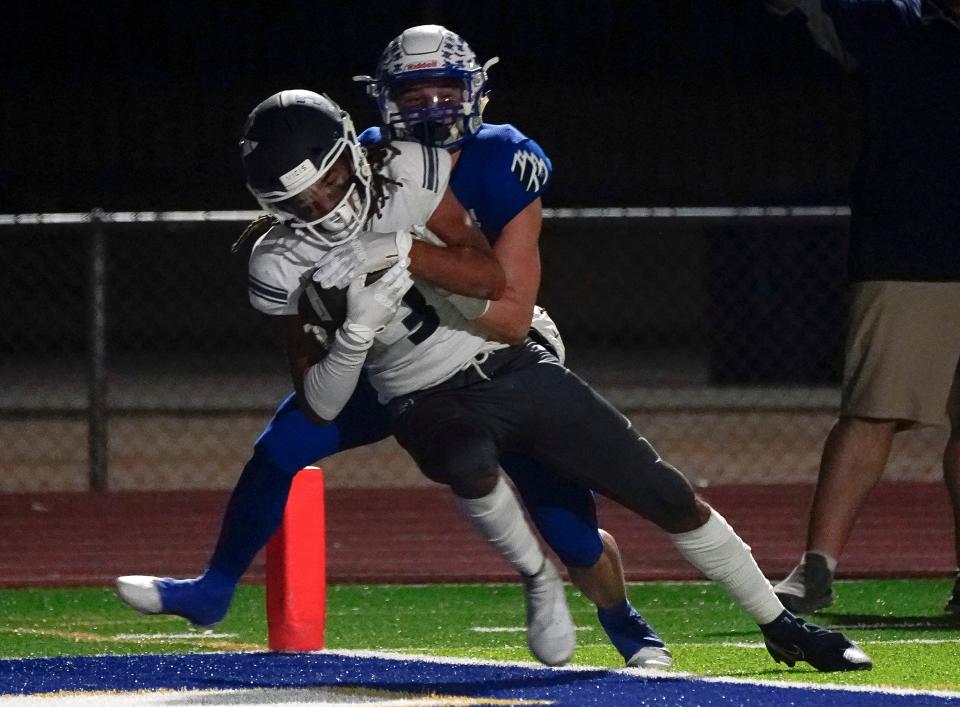 Pinnacle's Myles Libman (3) finds his way into the end zone against Sandra Day O'Connor's Kolten Warner (3)  during their first-round 6A playoff game in Phoenix on Nov. 19, 2021.