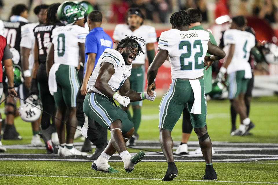 Tulane linebacker Nick Anderson (1) and running back Tyjae Spears (22) celebrate after Spears scored the game-winning touchdown against Houston in overtime during an NCAA college football game Friday, Sept. 30, 2022, in Houston. (Brett Coomer/Houston Chronicle via AP)