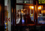 Two women wear face masks as the use a tram in Frankfurt, Germany, early Monday, Oct. 19, 2020. (AP Photo/Michael Probst)