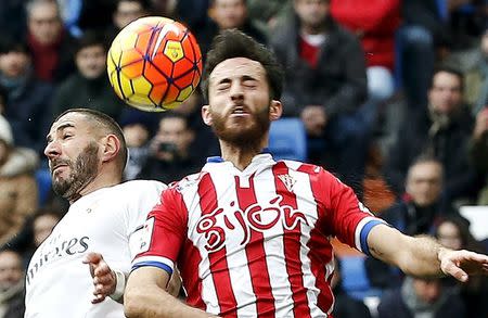 Football Soccer - Real Madrid v Sporting Gijon - Spanish Liga BBVA - Santiago Bernabeu, Madrid, Spain - 17/01/16. Real Madrid's Karim Benzema and Sporting Gijon's Alex Menendez in action. REUTERS/Andrea Comas