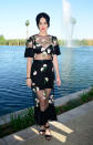 Katy Perry covers up her undergarments with a sheer black dress with flowers and sports a very on-theme braided crown.