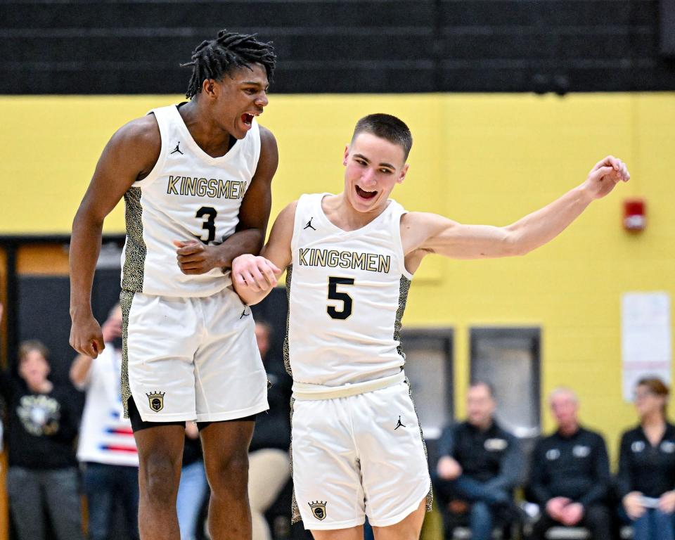 Penn's Markus Burton (3) celebrates with Ethan Good (5) as Burton came out of the game in the fourth quarter Friday, Jan. 20, 2023, at Penn High School. Penn won 66-52.