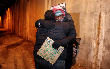 Richard S. Vargas, The Salvation Army Director of Community Social Services, hugs homeless Alvin Henry during cold wellness checkup in Chicago, Illinois, U.S., January 31, 2019. REUTERS/Kamil Krzaczynski