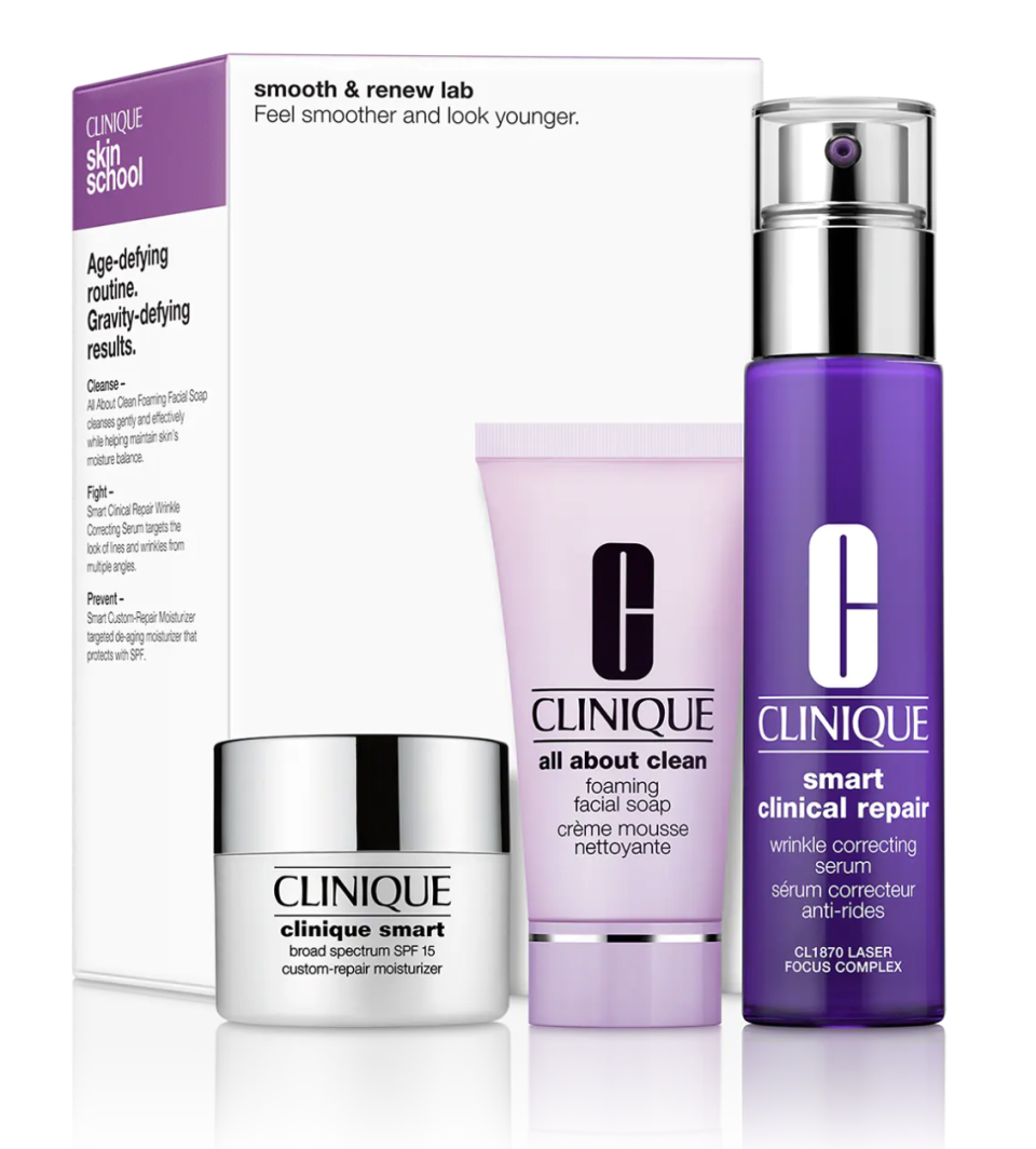 Clinique's Smooth & Renew Lab: Skin Care Set shown on a shiny background, including a white box, white and silver tub, mauve tube, and purple spray bottle.