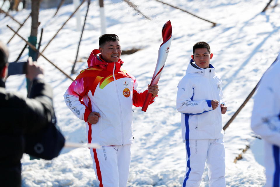 Olympics - Beijing 2022 Winter Olympics - Torch Relay - Beijing, China - February 2, 2022. Torch bearer Qi Fabao, a regimental commander in the People's Liberation Army, relays the Olympic flame at the Winter Olympic Park.  cnsphoto via REUTERS ATTENTION EDITORS - THIS IMAGE WAS PROVIDED BY A THIRD PARTY. CHINA OUT.