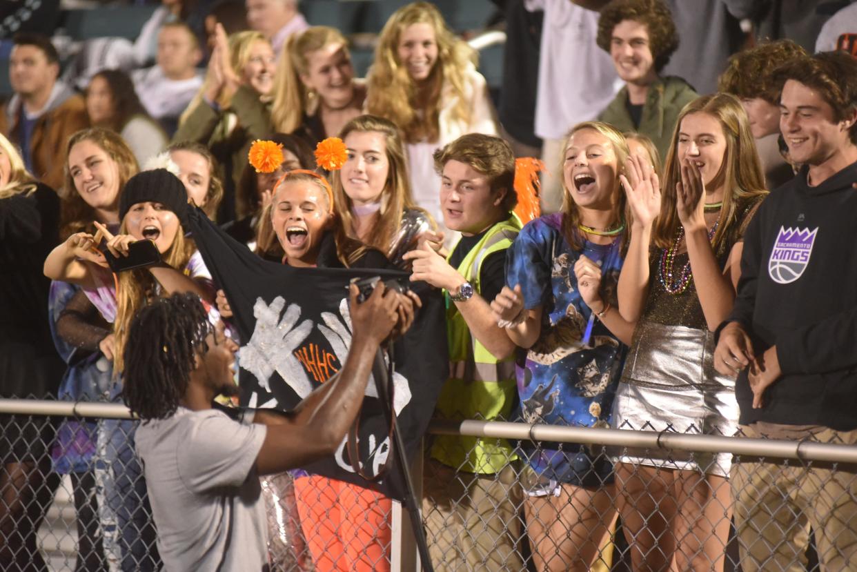 The New Hanover High School student section cheers on the Wildcats during a football game against North Brunswick.