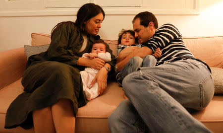 Noor Djait, 31, an architect and Ismail Benmiled, 36, a businessman pose for a photograph with their three-year-old son Said and four-month-old daughter Malek at their house in Tunis, Tunisia, February 9, 2018. Noor and Ismail lived on the same road and went to the same schools growing up, but never became close until they met in a nightclub when she was 17. "That night was the first time we really made eye contact with each other, the first time I talked to him. I remember I took off my shoes to dance on the table. At the end I only found one, Ismail found the other. He brought it to me two days later, like Cinderella." They began a relationship but, with Ismail five years her senior, she was concerned about their age difference and they broke up. But Ismail persisted, staying in contact with her, until he came to Rome years later, where she was finishing her architecture studies, proposing marriage shortly after. "We have been married for six years, we have two children and our love has not changed an iota. We are as in love as we were in the beginning," Djait said. REUTERS/ Zohra Bensemra