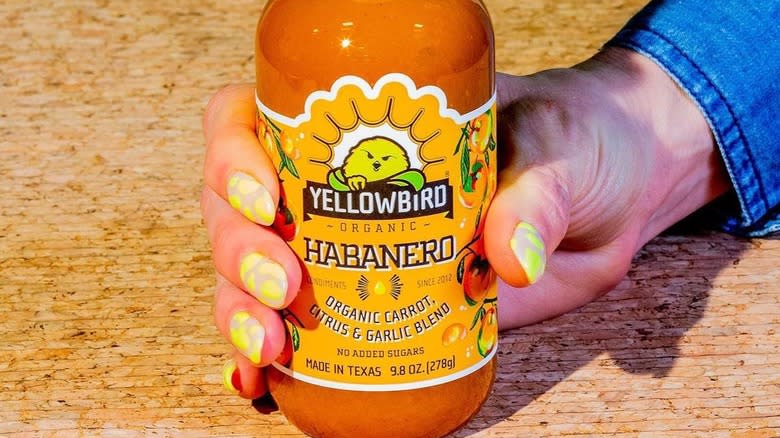 Yellowbird Habanero sauce in hand