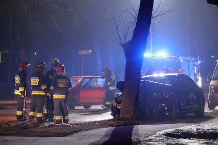 Firefighter officers inspect a site and Polish Prime Minister's Beata Szydlo's car after an accident in Oswiecim, Poland after car accident in Oswiecim, Poland February 10, 2017. Forum via REUTERS