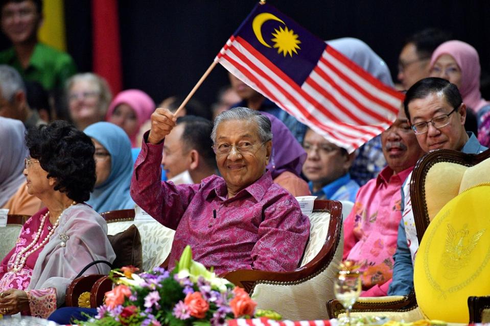 Prime Minister Tun Dr Mahathir Mohamad smiles as he waves the National flag during the Malaysia Day celebrations in Kuching September 16, 2019. — Bernama pic