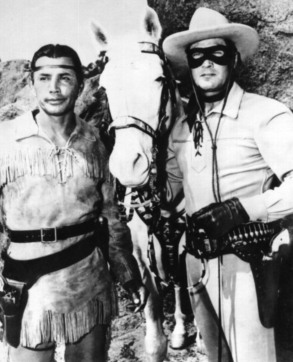 This 1959 file photo shows actor Clayton Moore in the role of the Lone Ranger, right, along with Tonto, played by Jay Silverheels, left, and the horse Silver.