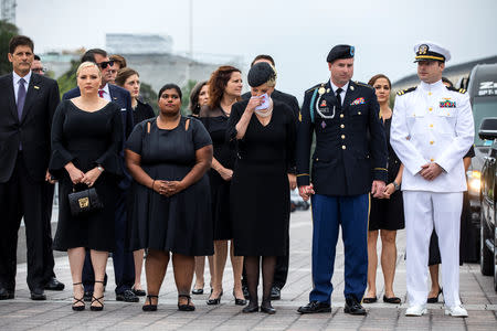 Members of the McCain family watch joint service members of a military casket team carry the casket of Senator John McCain from the US Capitol to a motorcade that will ferry him to a funeral service at the National Cathedral in Washington, US. September 1, 2018. Jim lo Scalzo/POOL Via REUTERS 