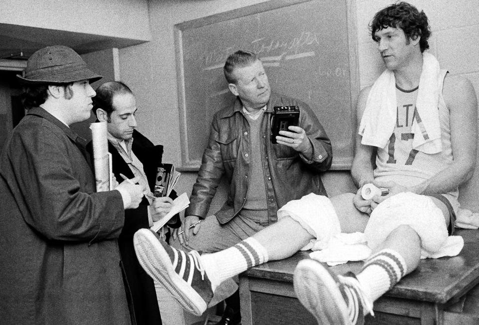 FILE - In this March 17, 1976 file photo, Boston Celtics' John Havlicek chats with newsmen after an NBA workout in Lexington, Mass. The Boston Celtics say Hall of Famer John Havlicek, whose steal of Hal Green’s inbounds pass in the final seconds of the 1965 Eastern Conference finals against the Philadelphia 76ers remains one of the most famous plays in NBA history, has died. The team says Havlicek died Thursday, April 25, 2019 at age 79. (AP Photo/ File)