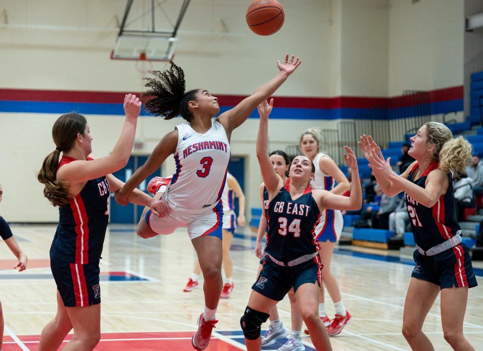 Neshaminy's Alena Cofield (3) goes for a rebound ball against Central Bucks East's Jess Lockwood (32), Chantal Van Dongeren (34), and Natalie Berndt (21) during their girls’ basketball game in Langhorne on Wednesday, Jan.31, 2024. 

Daniella Heminghaus | Bucks County Courier Times